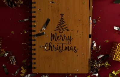 Brown notebook on dark red background.