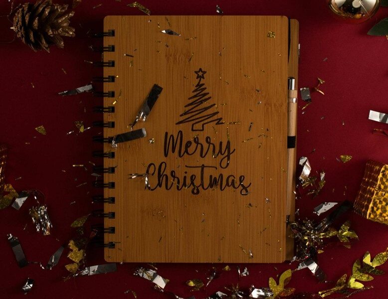 Brown notebook on dark red background.